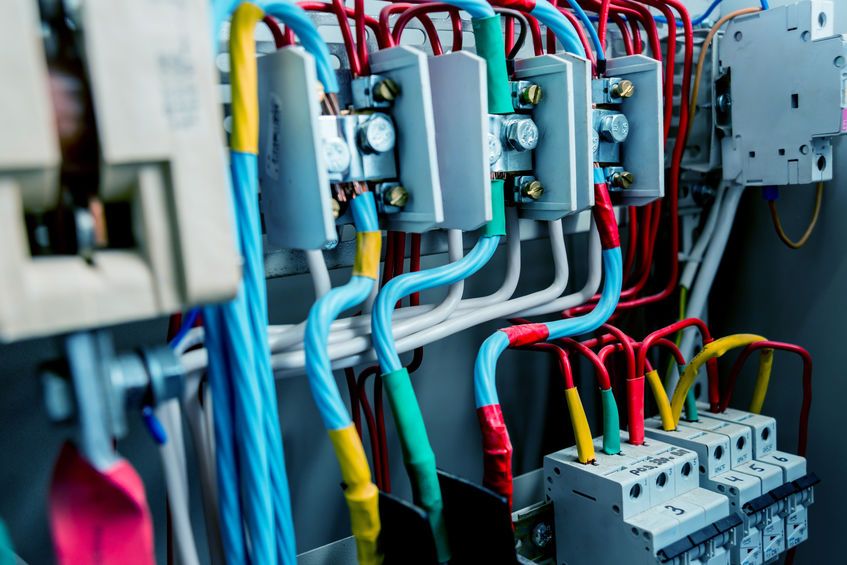 Wires and switches in electric box. Electrical panel with fuses and contactors. Background and texture